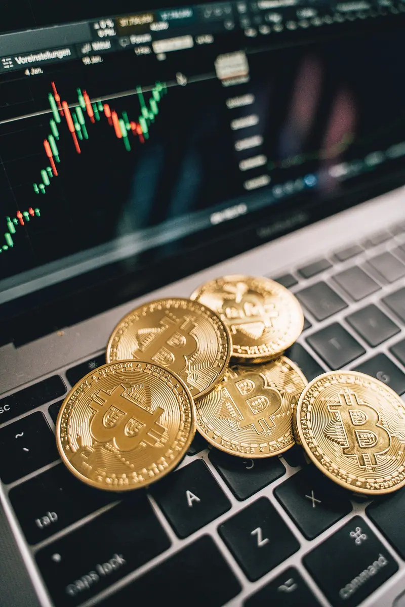 Crypto coins on a laptop, illustrating guides to learning about crypto in Indonesia